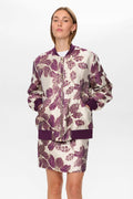 Woman wearing a floral-patterned outfit on a white background