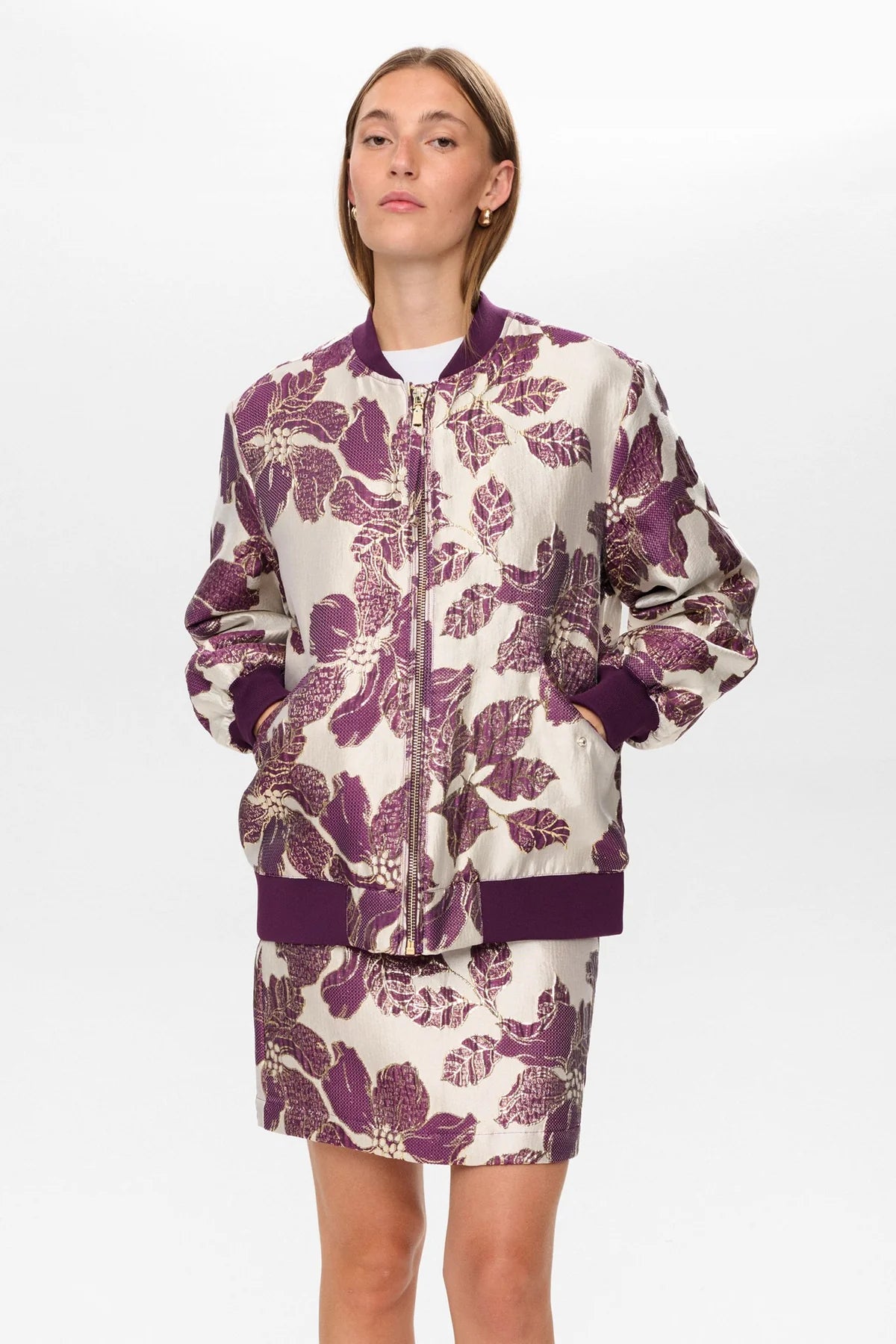 Woman wearing a floral-patterned outfit on a white background