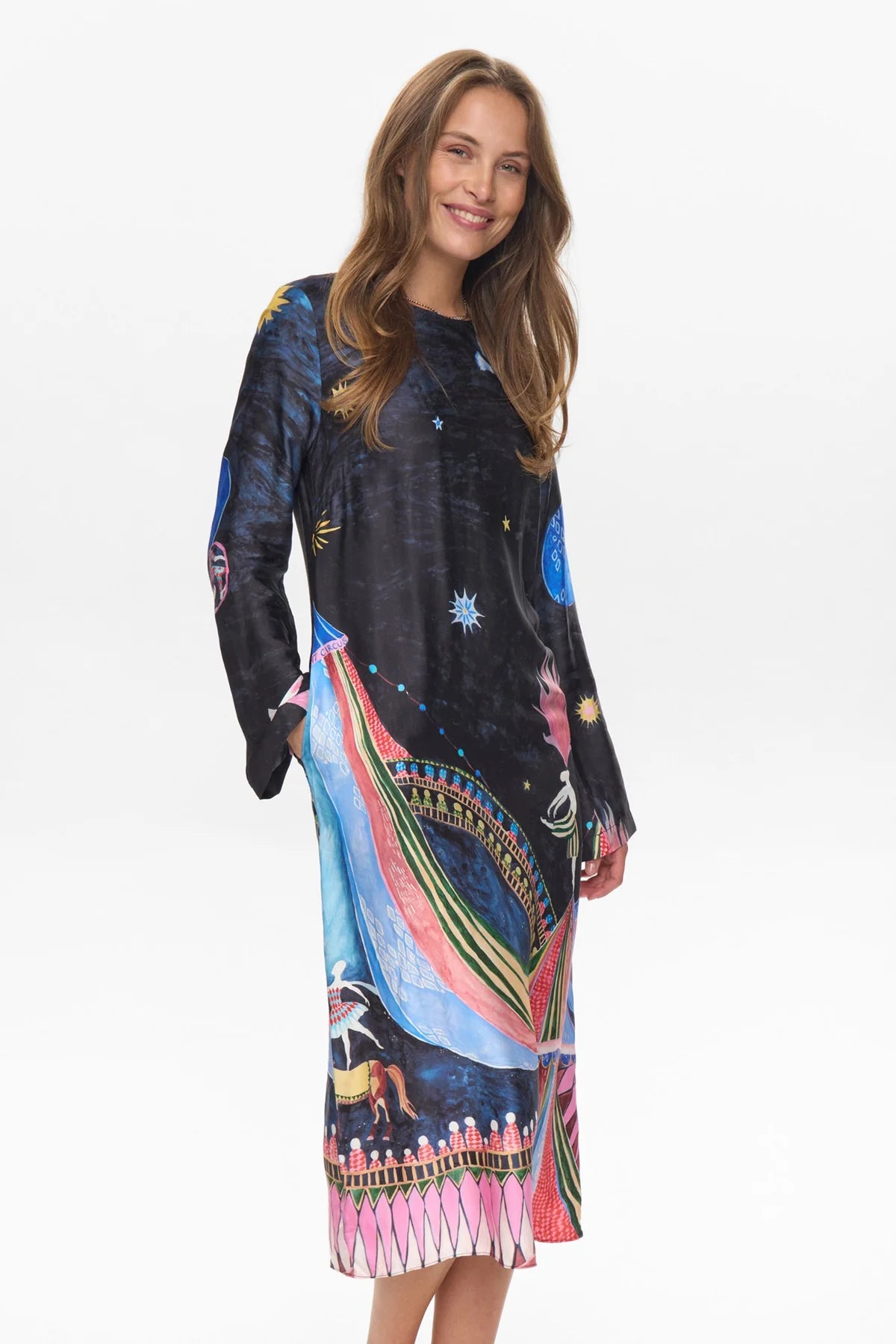 Woman wearing a colorful dress with abstract patterns on a white background