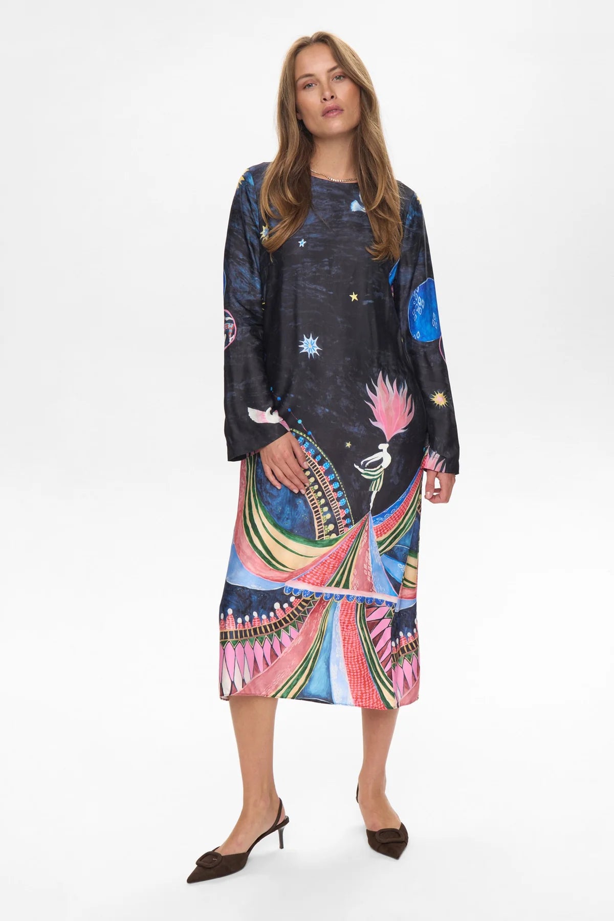 Woman wearing a colorful dress with abstract patterns on a white background