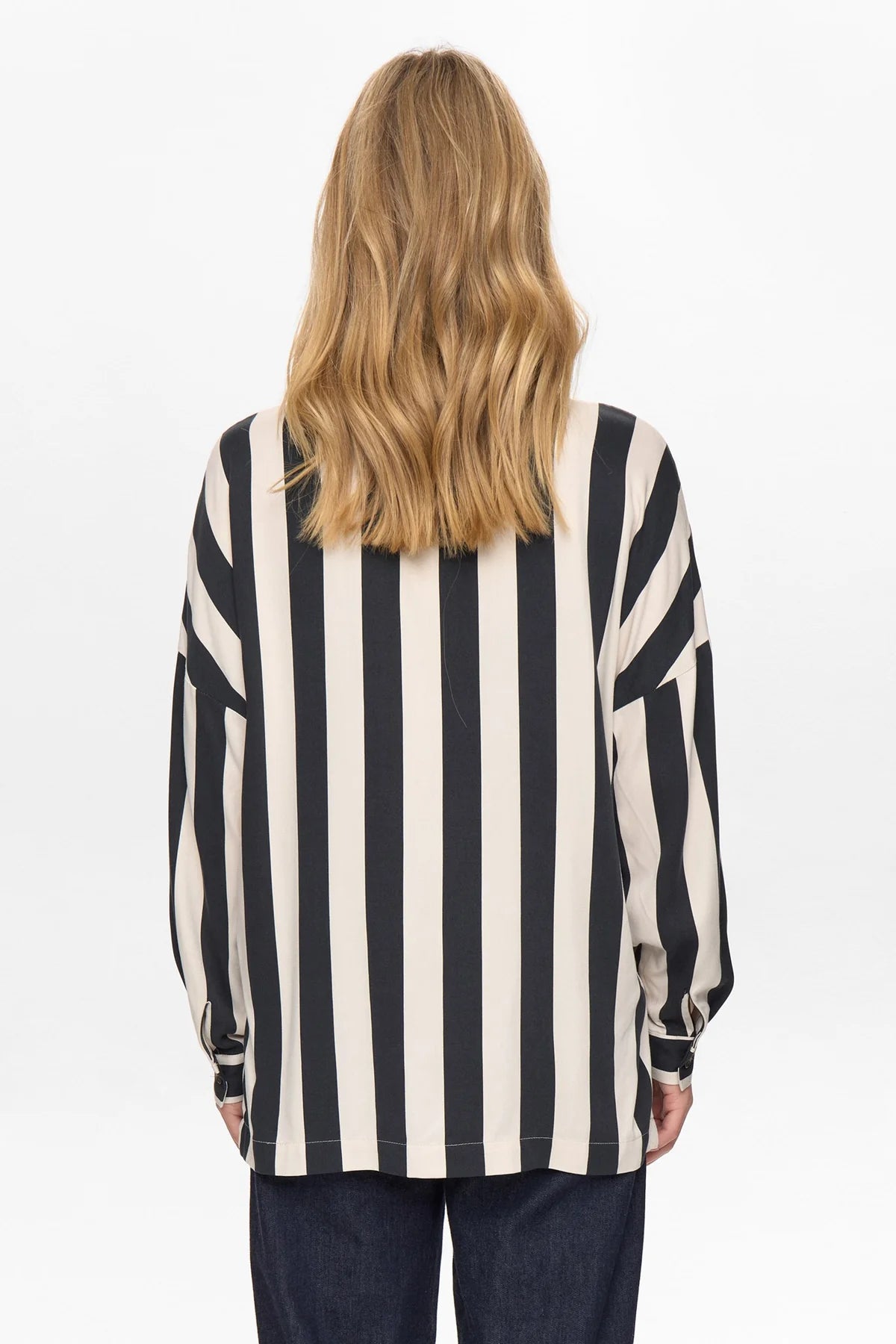 Person wearing a black and white striped shirt on a white background