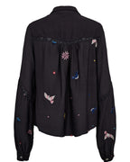Black shirt with colorful embroidery on a white background