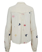 White shirt with colorful embroidery on a white background