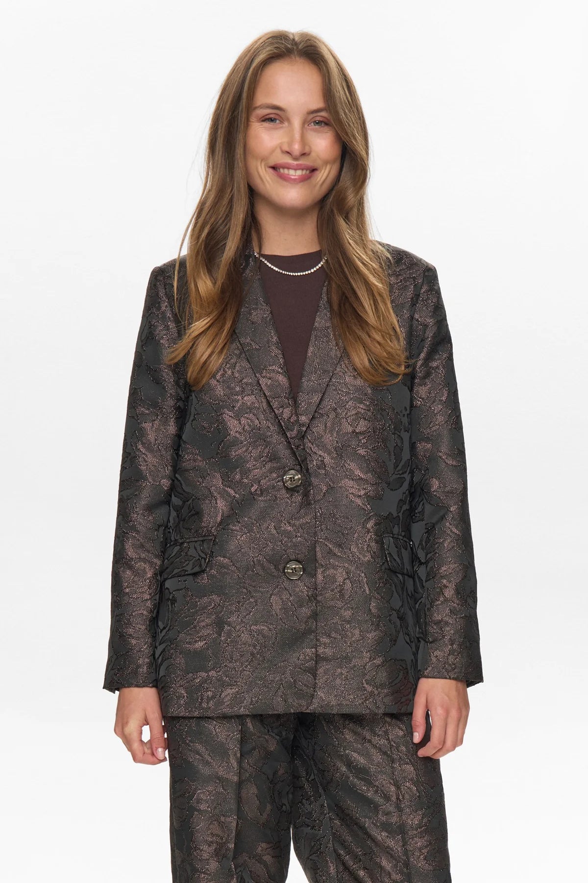 Woman wearing a patterned suit on a white background