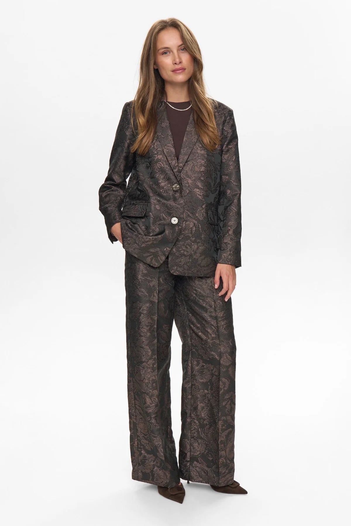 Woman wearing a patterned suit on a white background