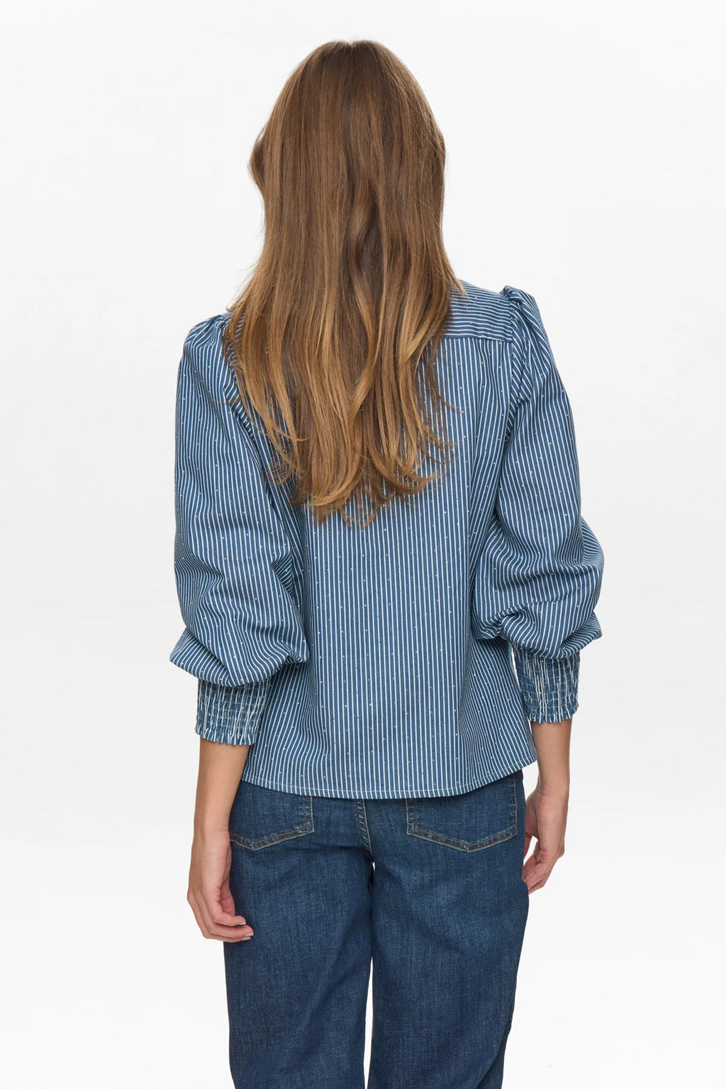 Person wearing a blue striped shirt and jeans on a white background