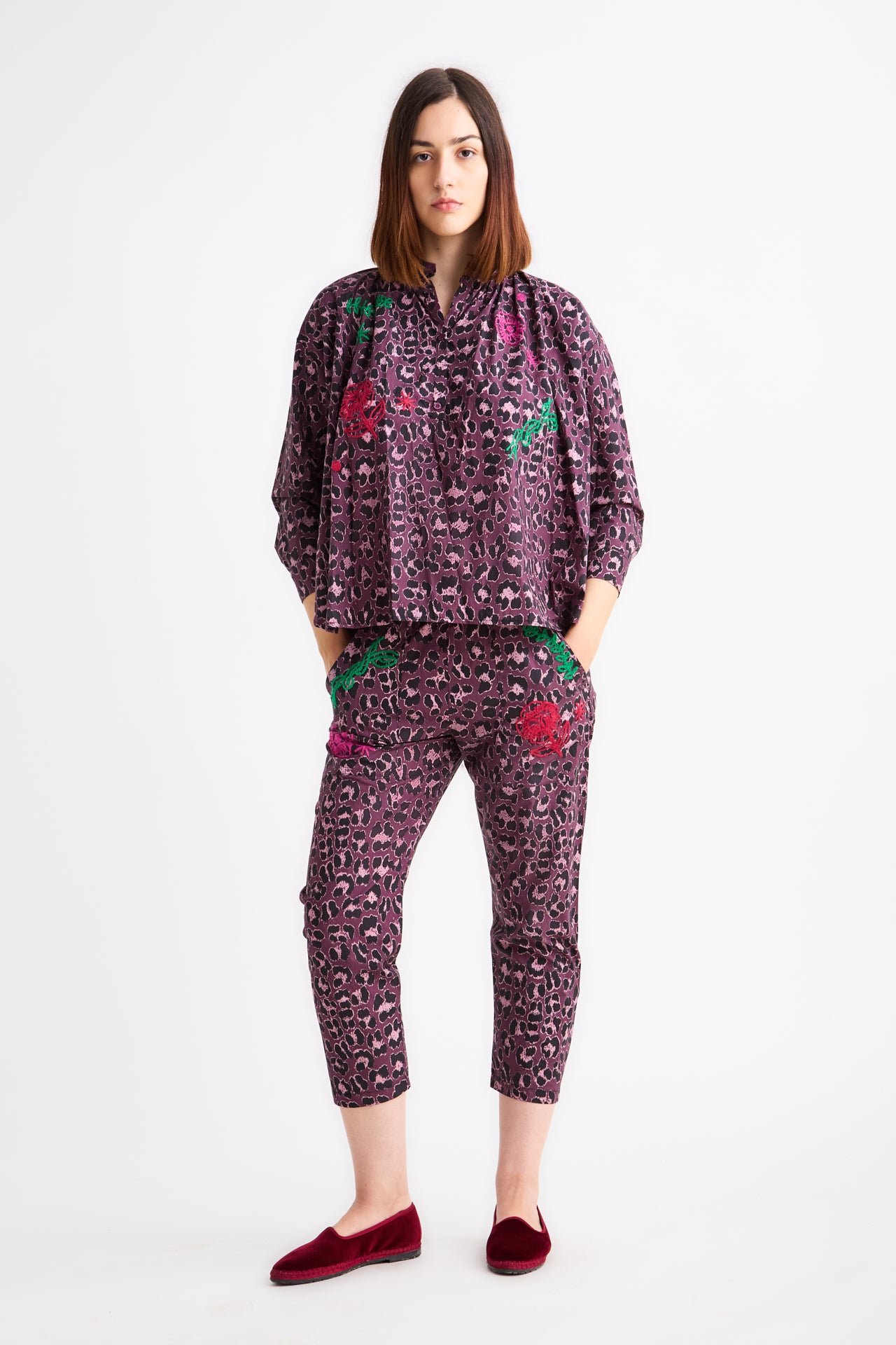 Woman wearing a patterned outfit on a white background