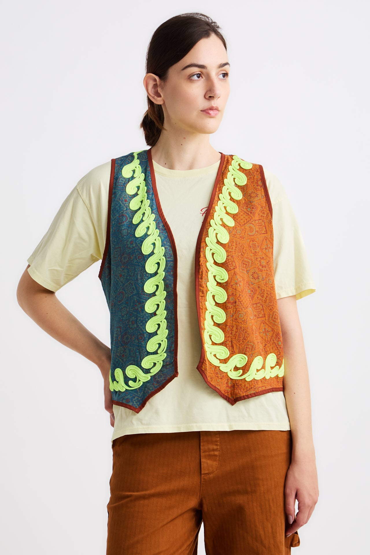 Woman wearing a colorful vest with a white background