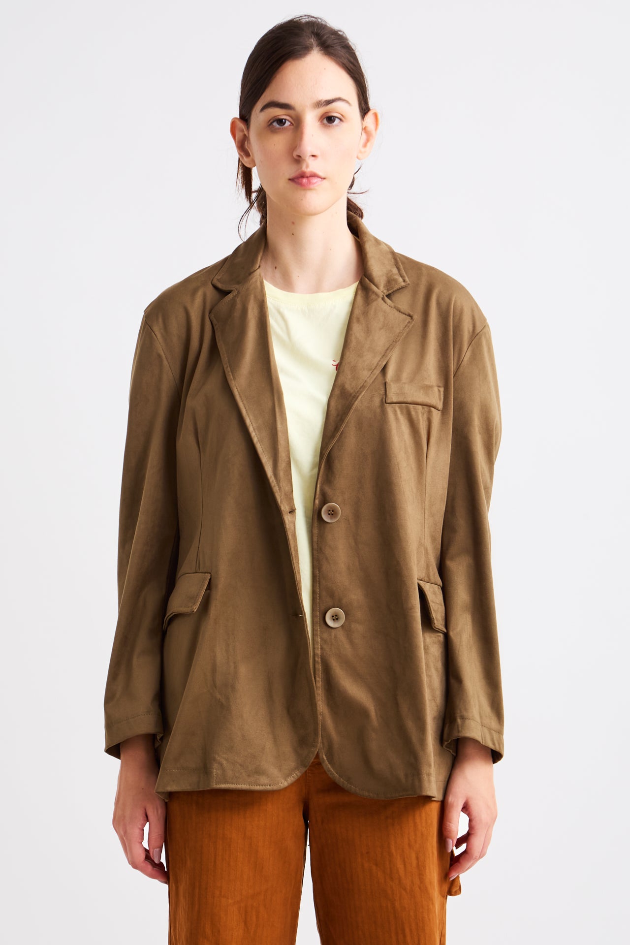 Person wearing a brown jacket and pants on a white background