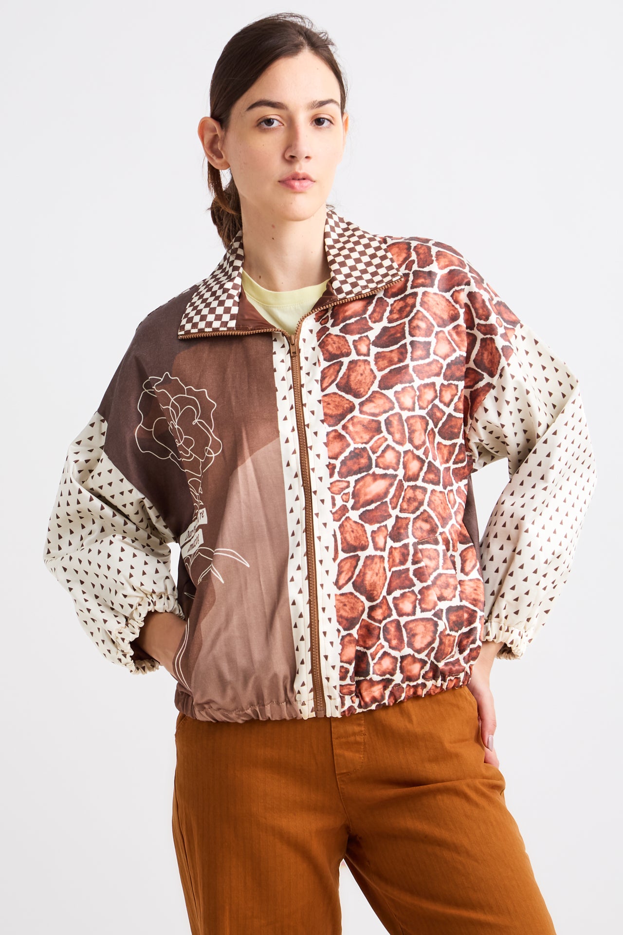 Person wearing a patterned jacket with a mix of colors on a white background