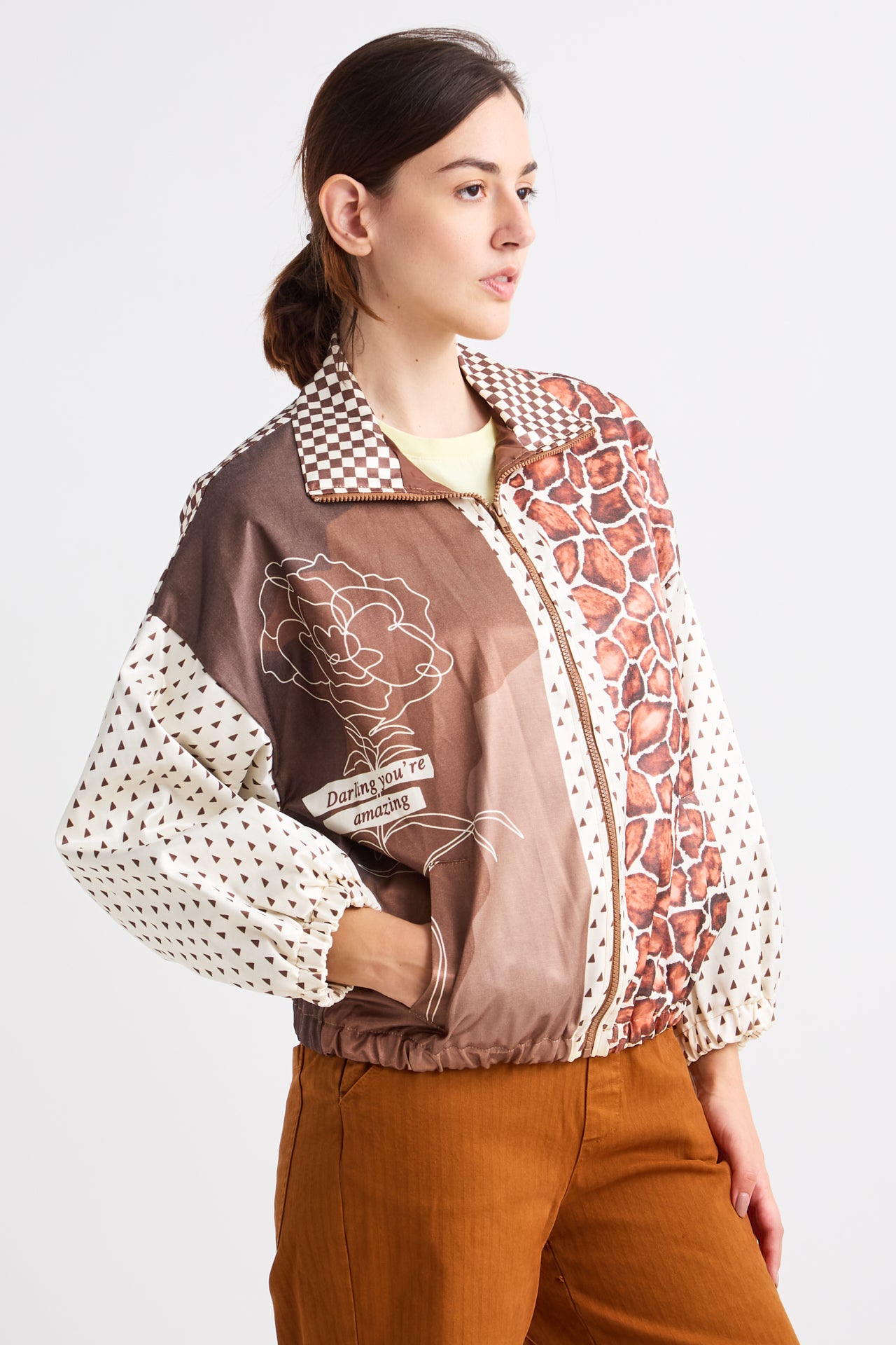 Woman wearing a patterned jacket with a white background