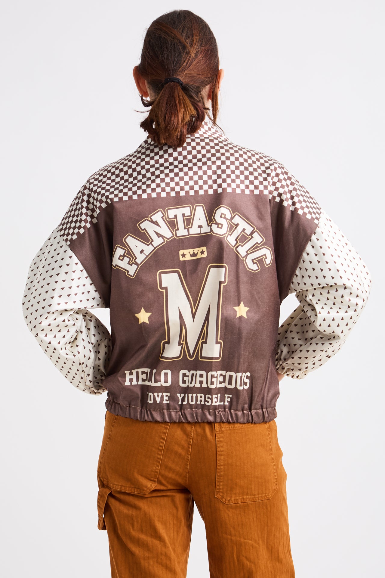 Person wearing a checkered jacket with text and graphics on a white background