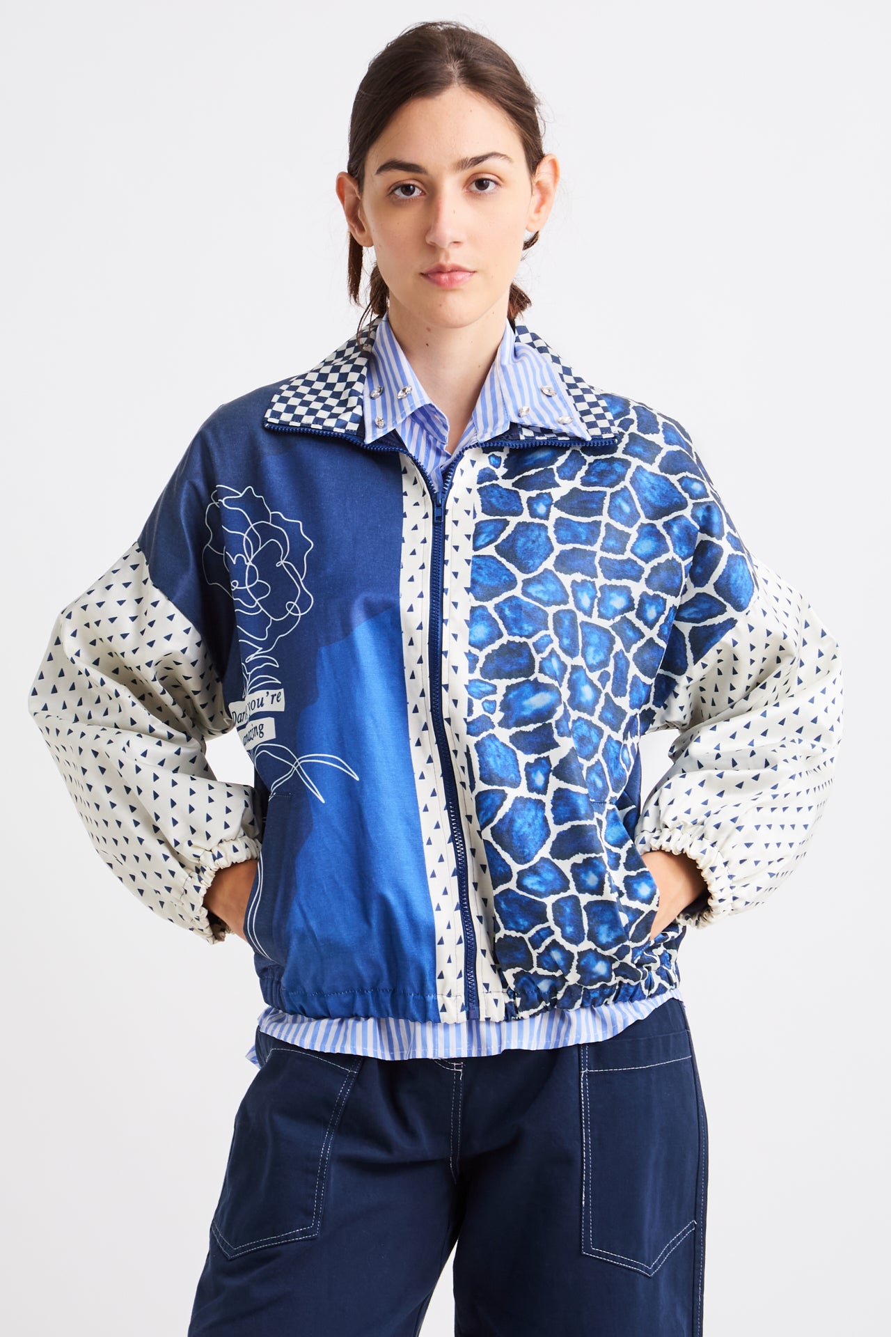 Person wearing a blue patterned jacket on a white background