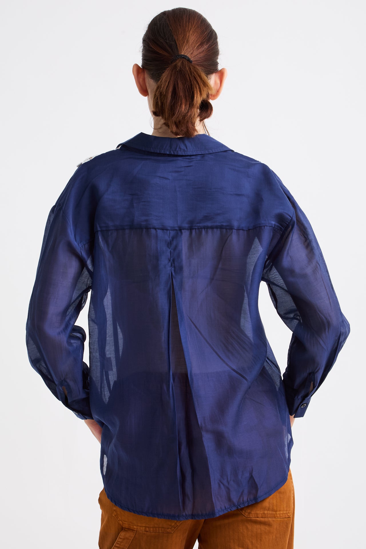 Person wearing a blue jacket on a white background