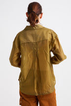 Person wearing a green jacket on a white background