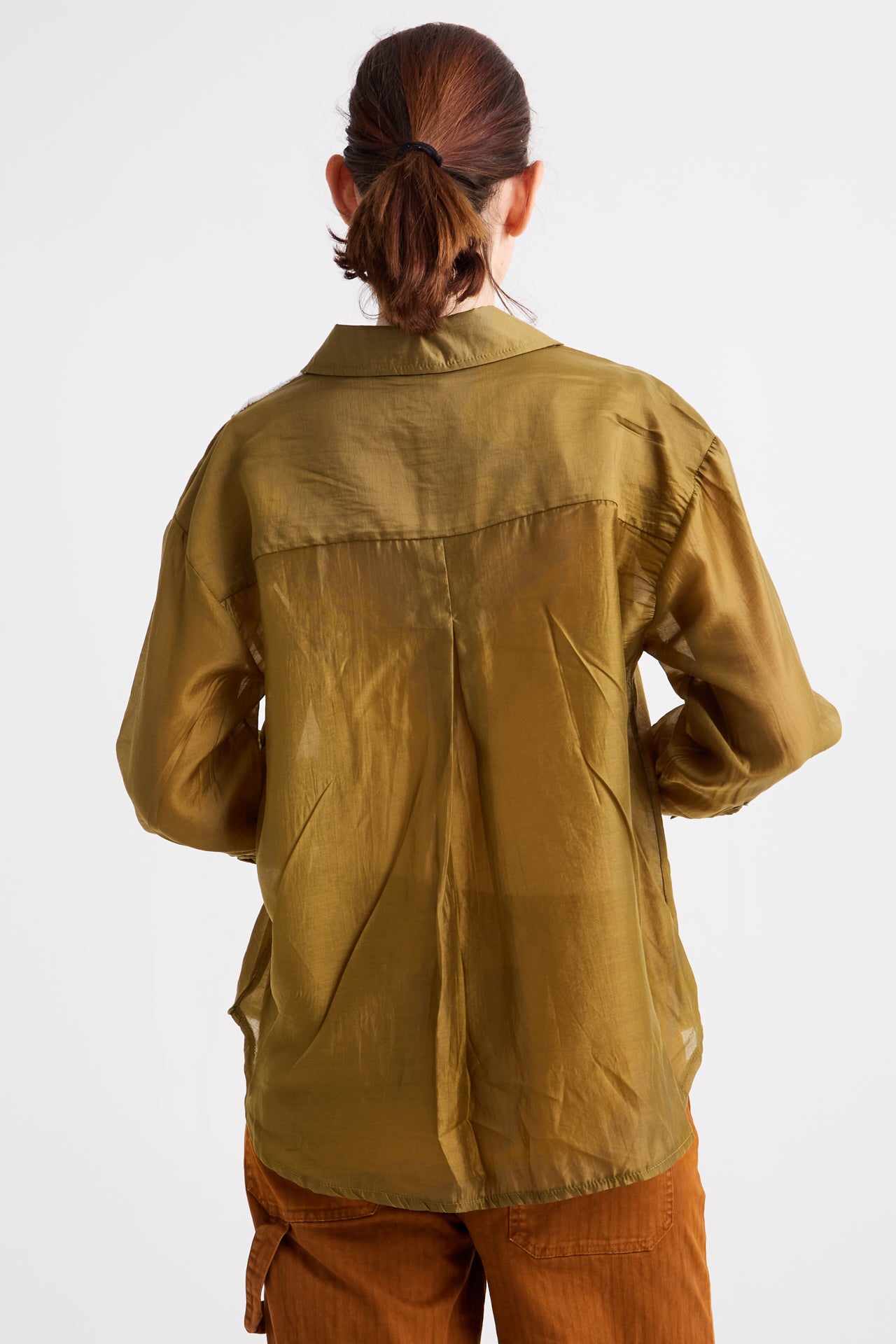 Person wearing a green jacket on a white background